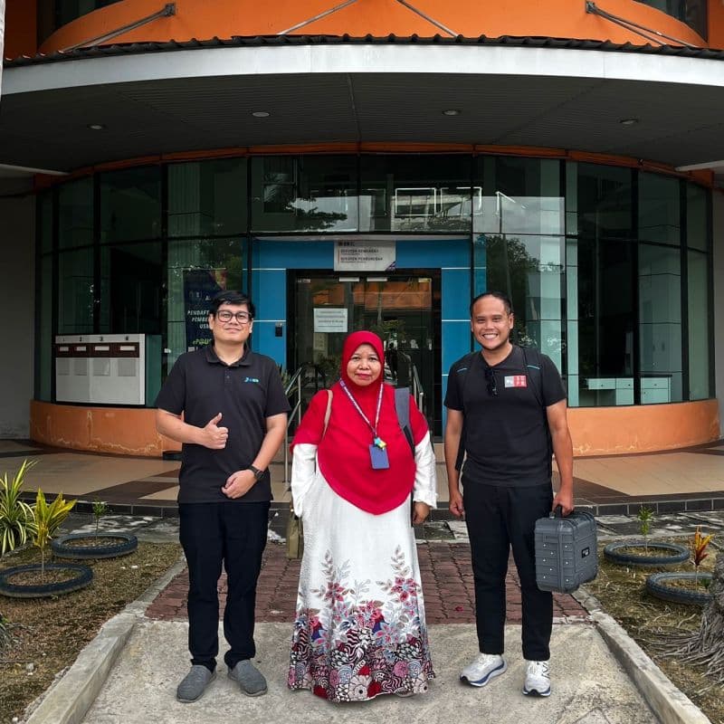 3D Gens team members pose with a client representative outside an institution in northern Malaysia