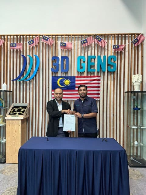 Two representatives display a document together at the 3D Gens office